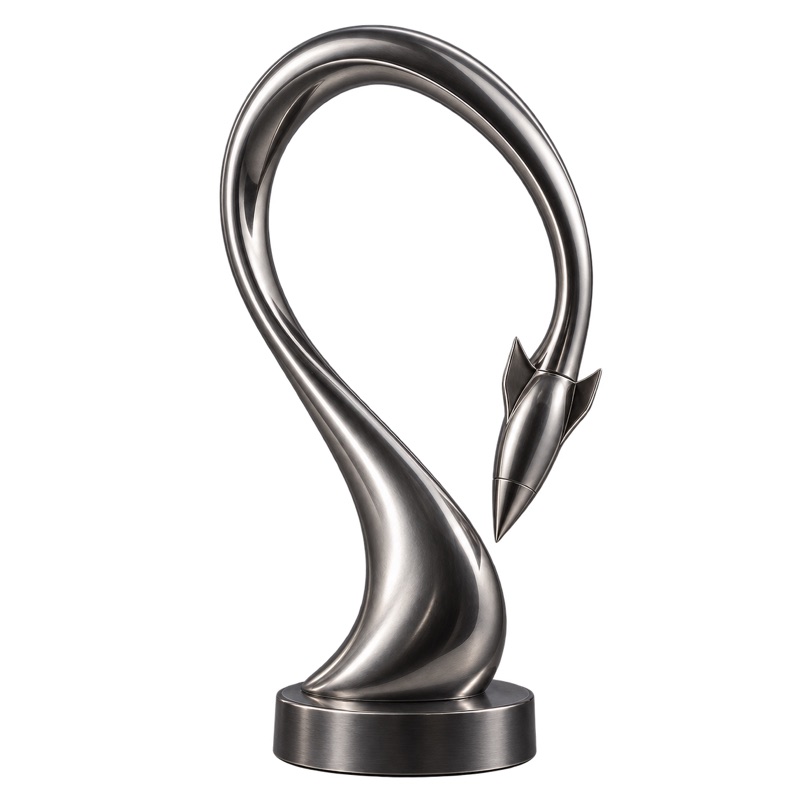 The Backfire statuette in lead: a rocket that loops up and turns back on itself, on a round base